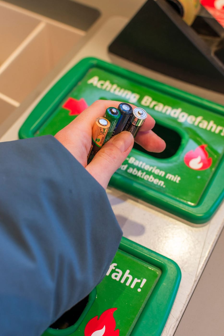 Dropping used batteries into a B-cycle recycling bin