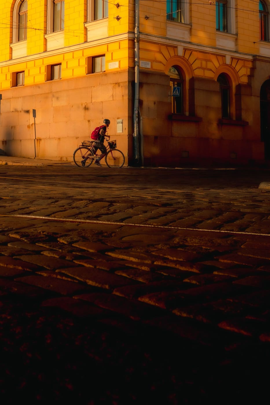 Cyclist riding through a city at golden hour